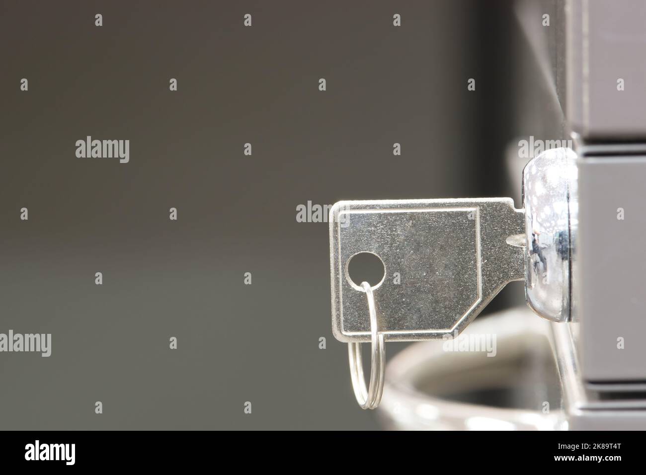 Generic key inserted in a filing lock. Side view closeup with