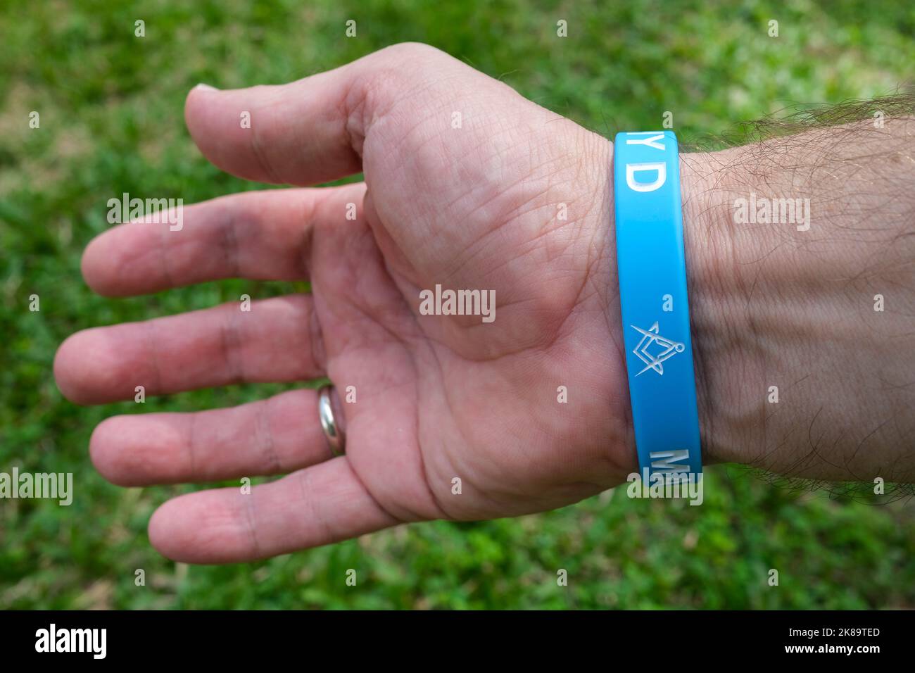 plastic wristband with a freemason square and compasses symbol Stock Photo