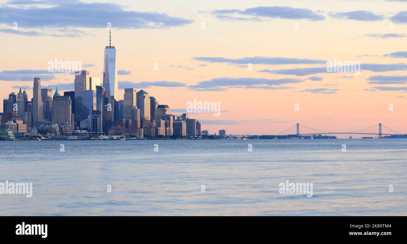 The skyscrapers of New York City (Lower Manhattan) view from water after the sunset, USA Stock Photo
