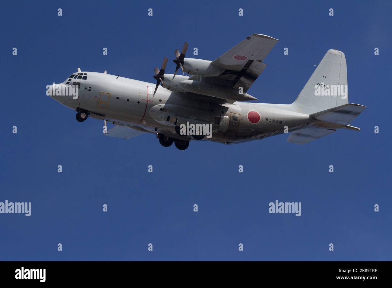 A Lockheed C130 Hercules transport aircraft with the Japanese Maritime Self Defence Force (JSMSDF) Fleet air Wing 4 flies near Naval air facility Atsu Stock Photo