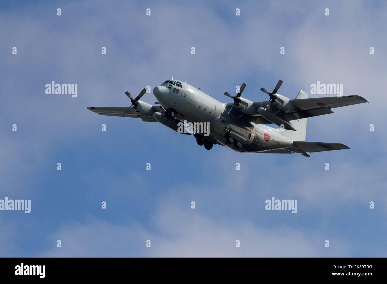 A Lockheed C130 Hercules transport aircraft with the Japanese Maritime Self Defence Force (JSMSDF) Fleet air Wing 4 flies near Naval air facility Atsu Stock Photo