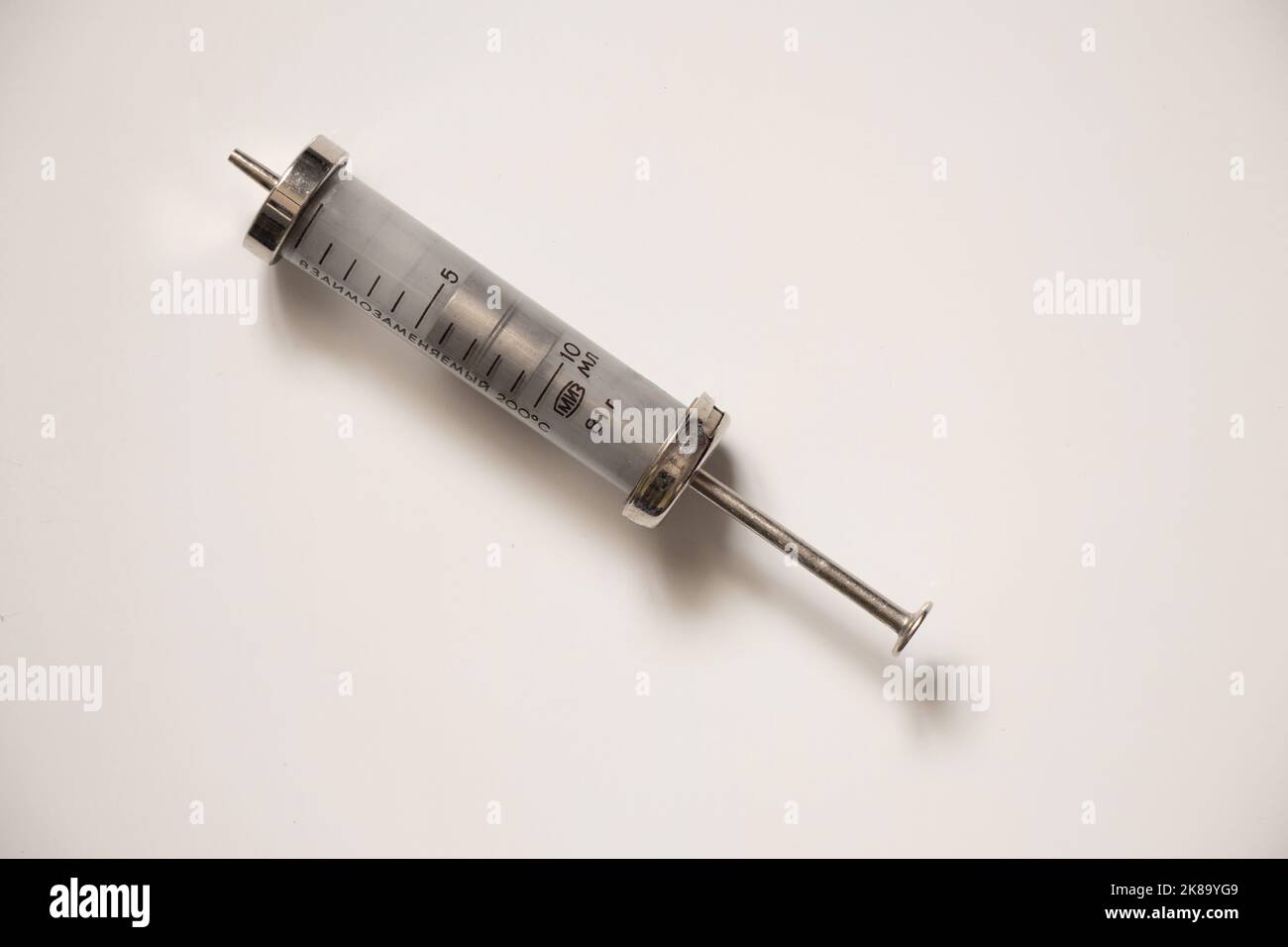 interchangeable old glass syringe on a white background, injections and syringes antiques Stock Photo