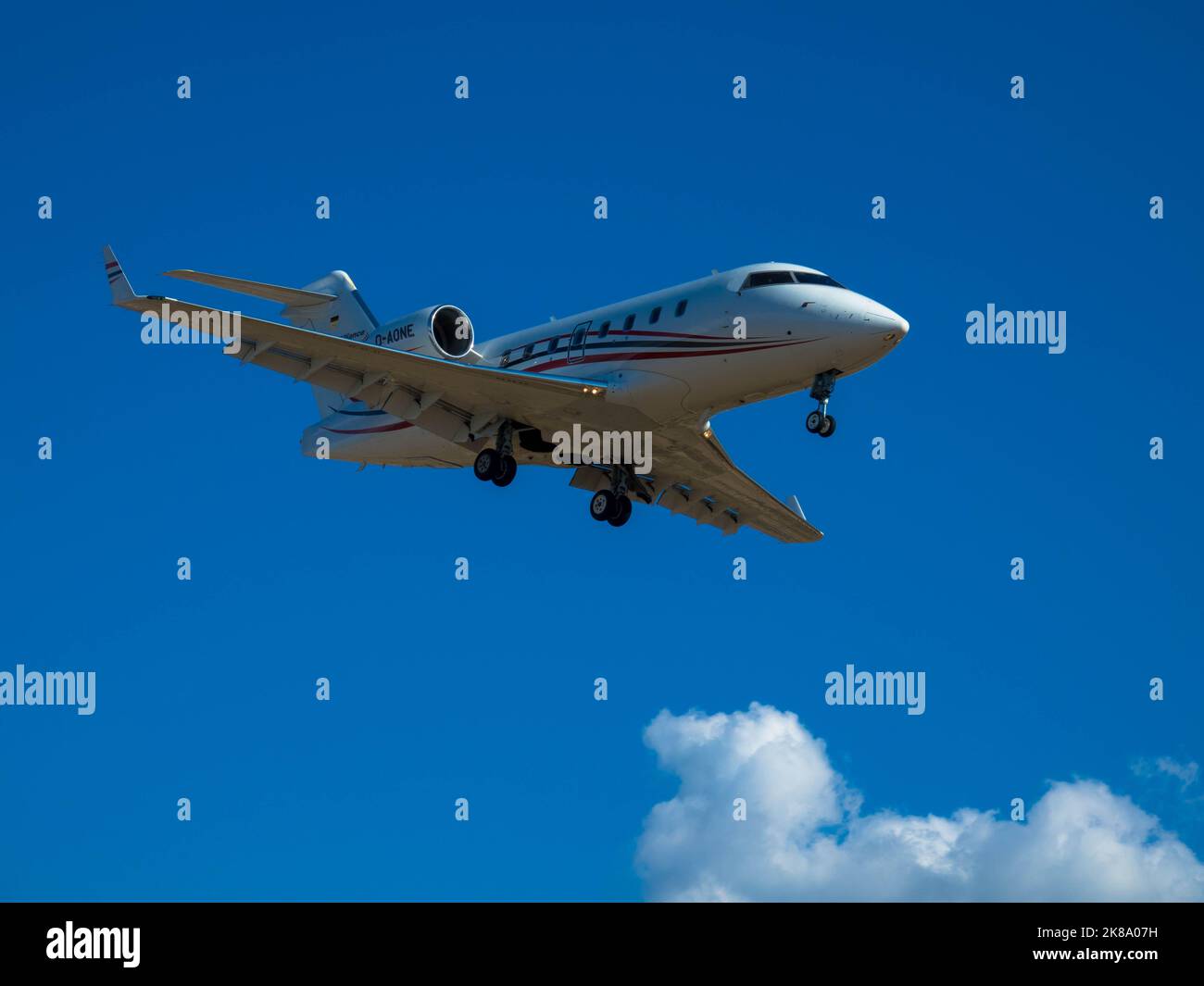 Private jet on approach for landing. Blue sky with plenty of space for text. 08 October 2022, Rhodes, Greece Stock Photo