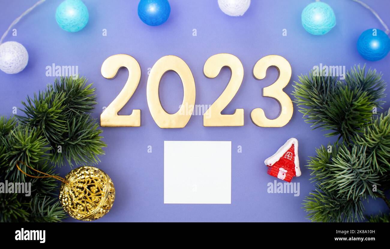 Christmas tree branches with paper card note. Flat lay. Nature New Year concept. Stock Photo