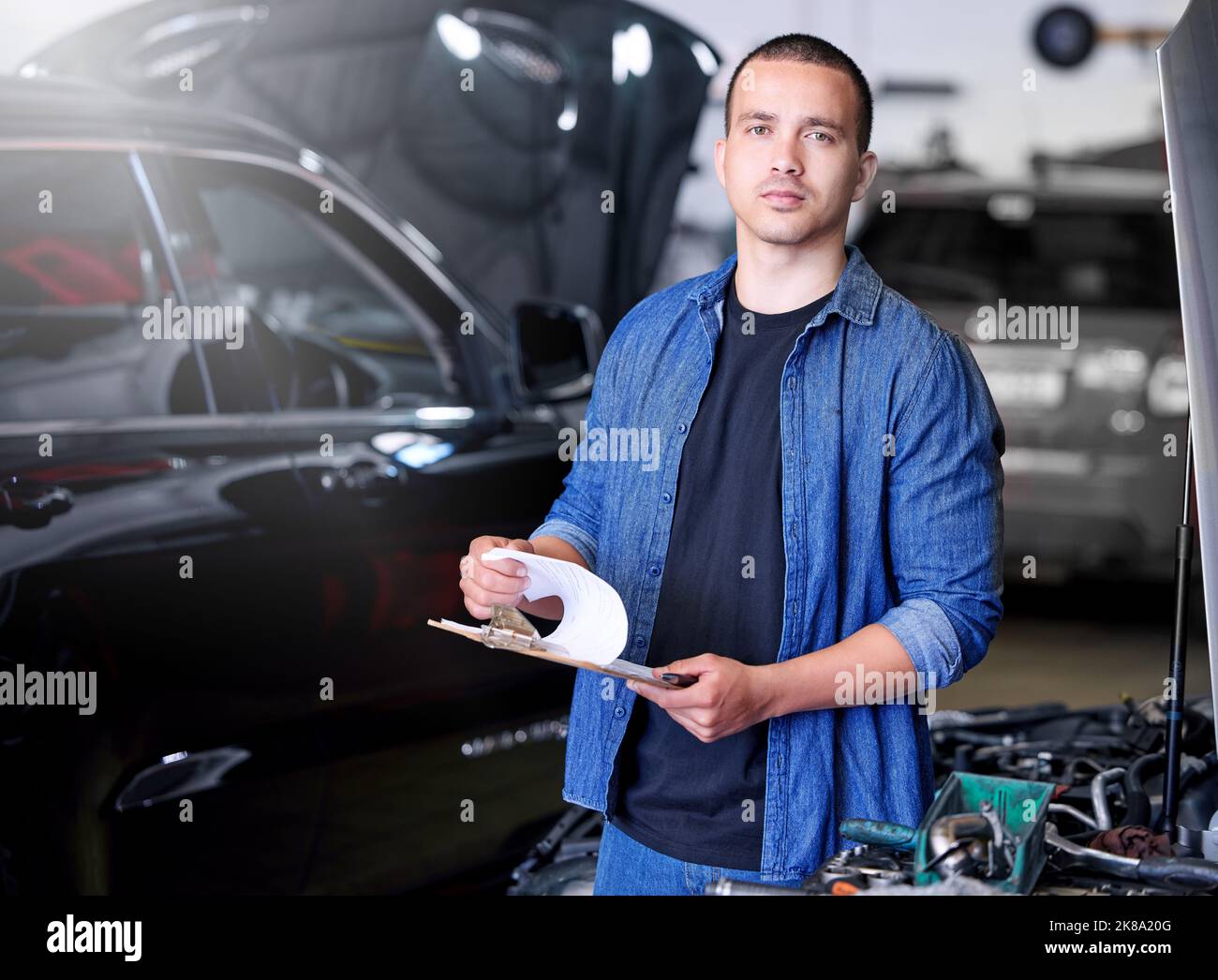 Car, engineering and mechanic with a checklist at a or garage