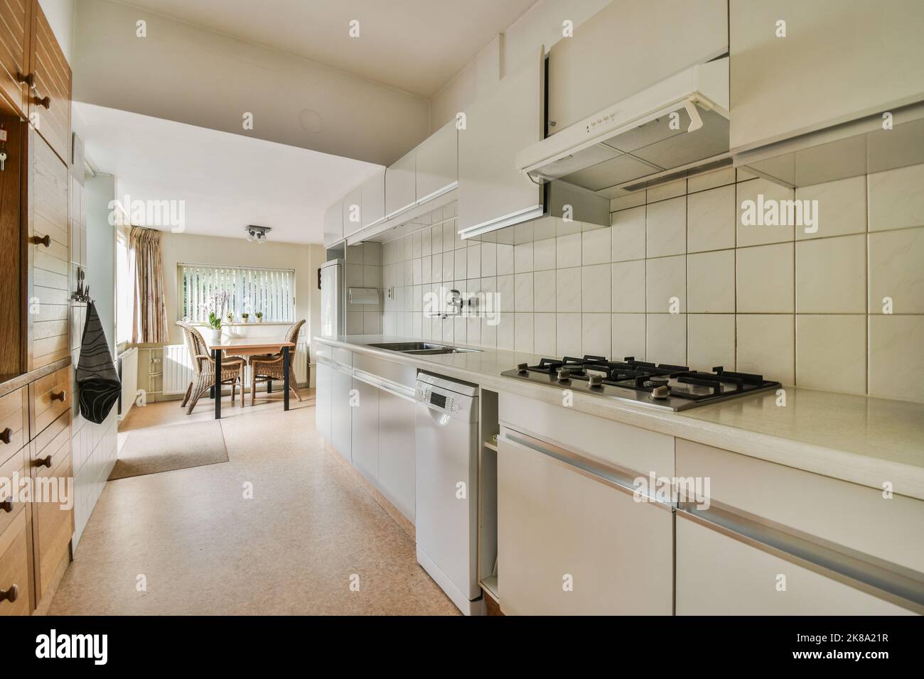 Counters with stove and oven located in modern kitchen near dining room at home Stock Photo