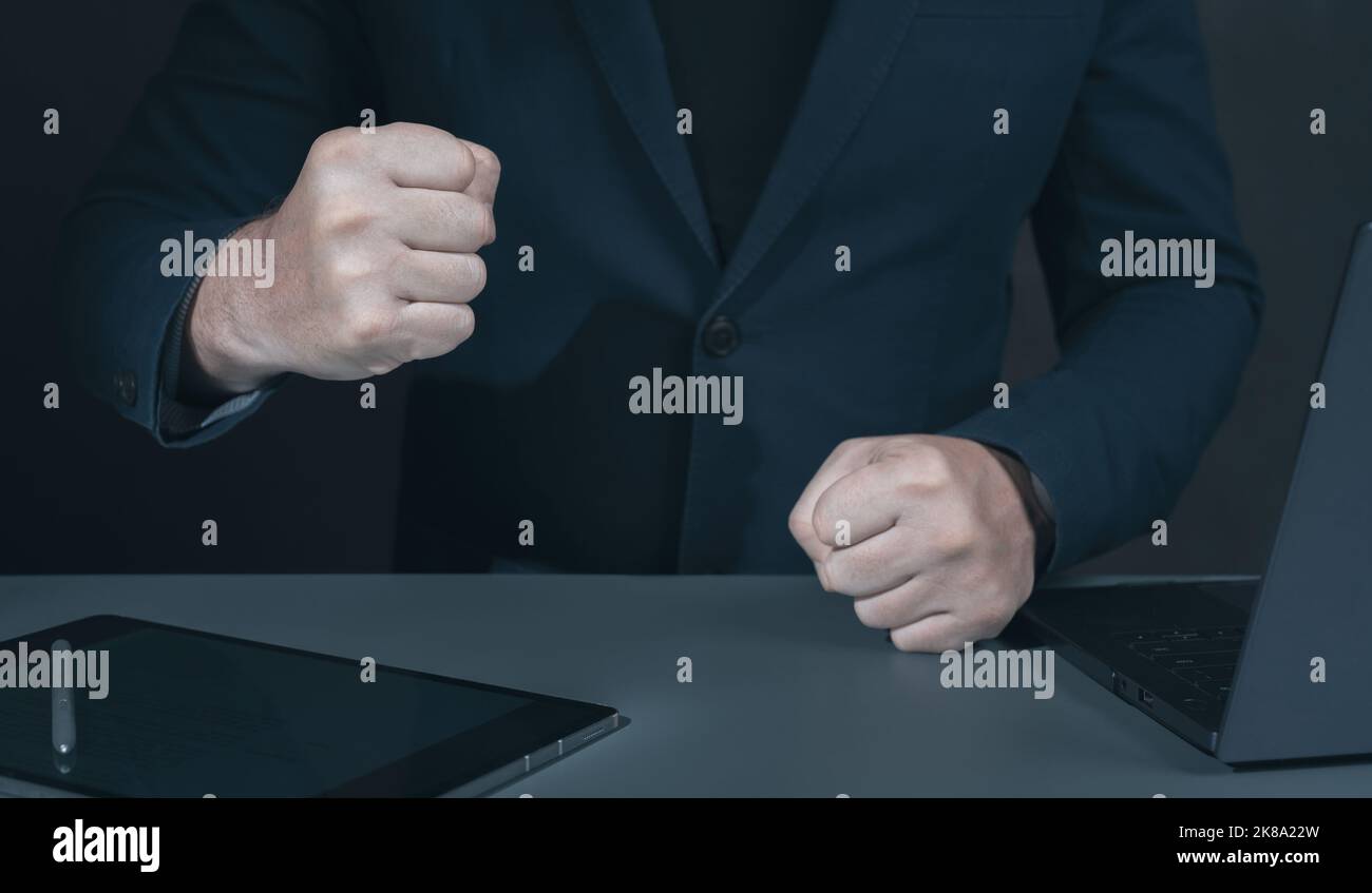 Businessman pounding fist on table, cropped image. Angry businessman
