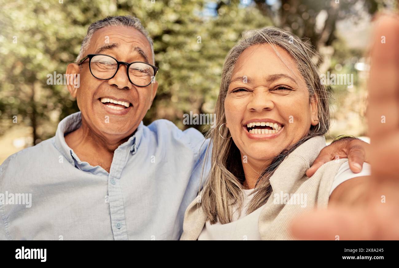 Selfie, portrait and funny senior couple with smile in park for love, care and adventure together for summer fun. Happy, laughing and healthy man and Stock Photo