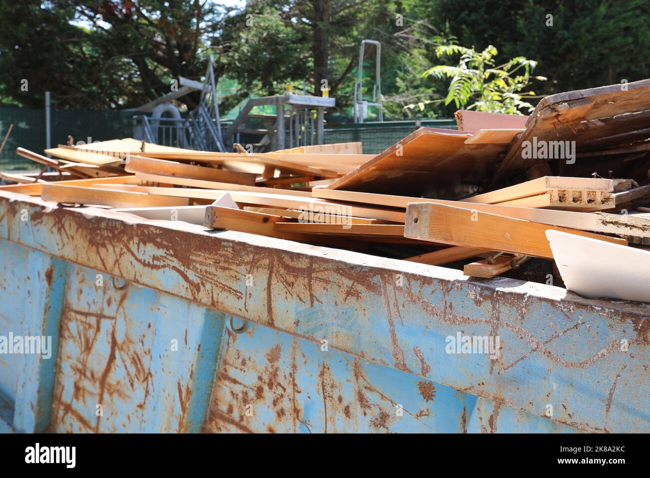 container with wooden planks and recycled material in the recycling