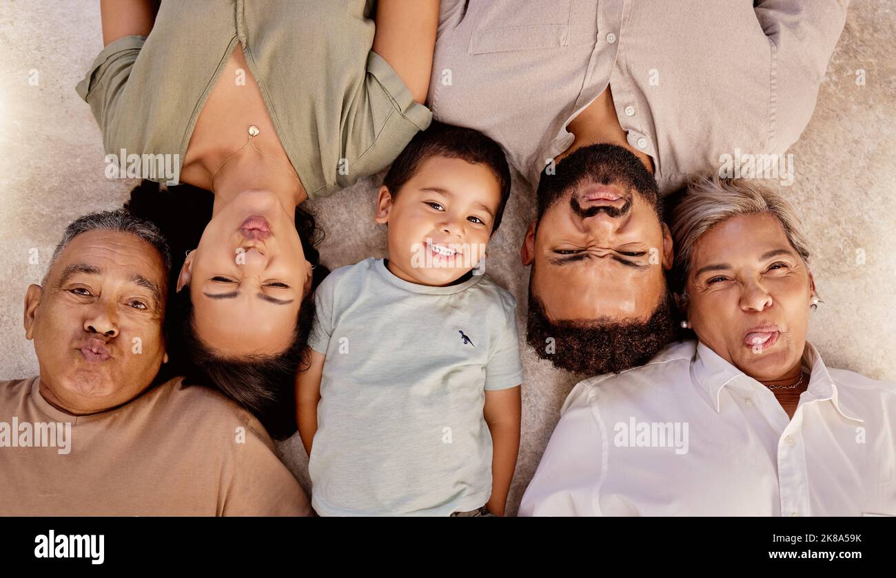 Relax, portrait and happy family with funny faces or crazy facial expressions lying on a floor, top view. Grandparent, mother and father love freedom Stock Photo