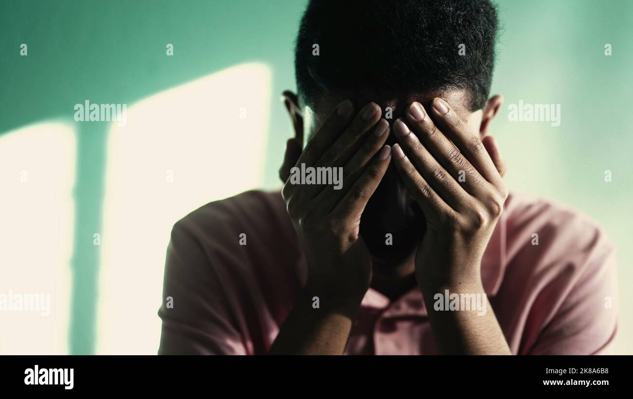 Suffer Face Depressed young man covering face with hand feeling ANXIETY. Suffering ...