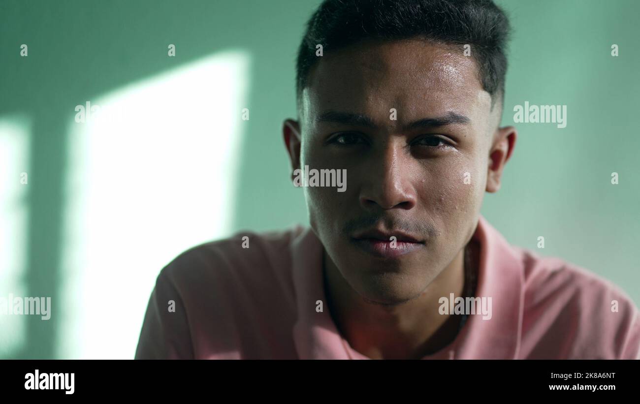 Portrait of a serious hispanic young man looking at camera. Closeup ...
