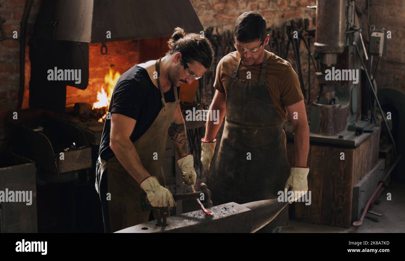 Nothing is impossible in our workshop. two metal workers working together in a workshop. Stock Photo