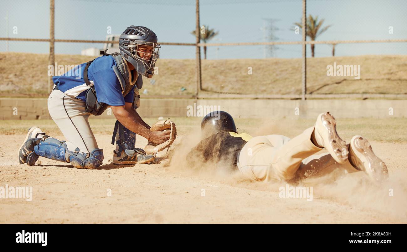 Baseball, baseball player and diving on home plate sand of field ground sports pitch on athletic sports ball game competition. Softball match, sport Stock Photo