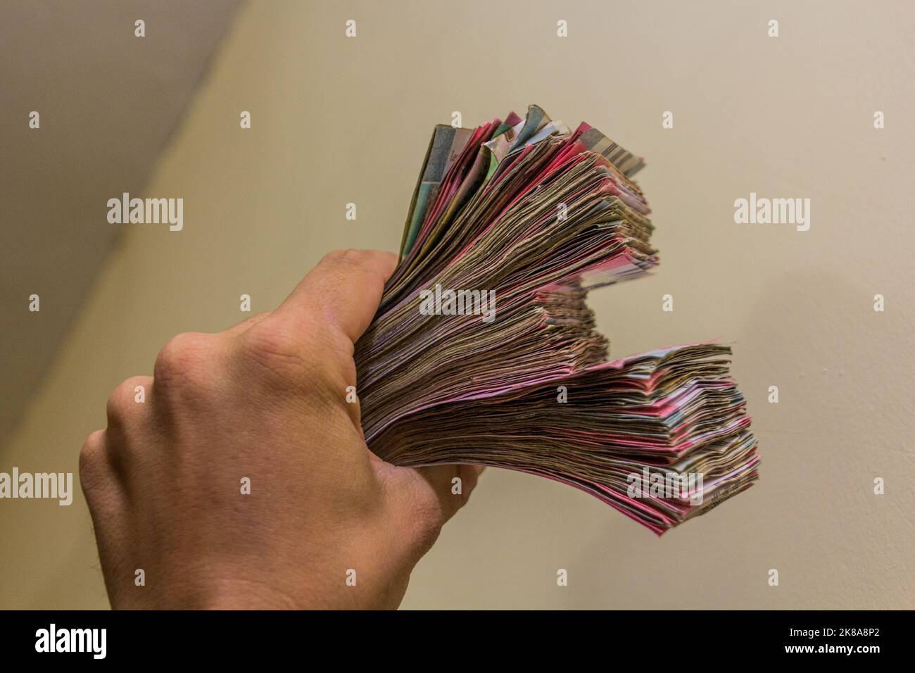Hand holding stacks of Sudanese Pound banknotes Stock Photo