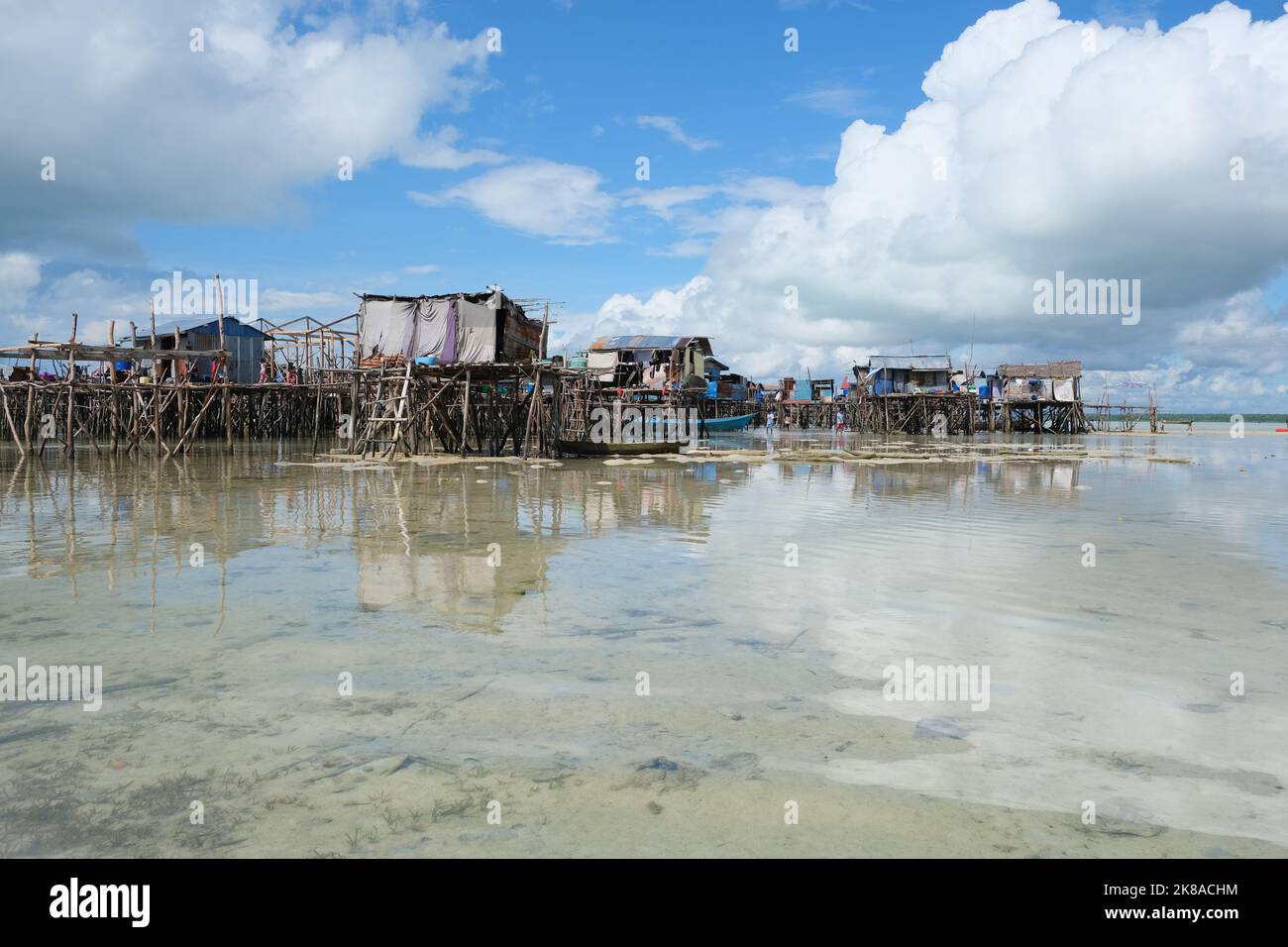 Omadal Island is a Malaysian island located in the Celebes Sea on the state of Sabah. The bajau laut village community during low tide time. Stock Photo