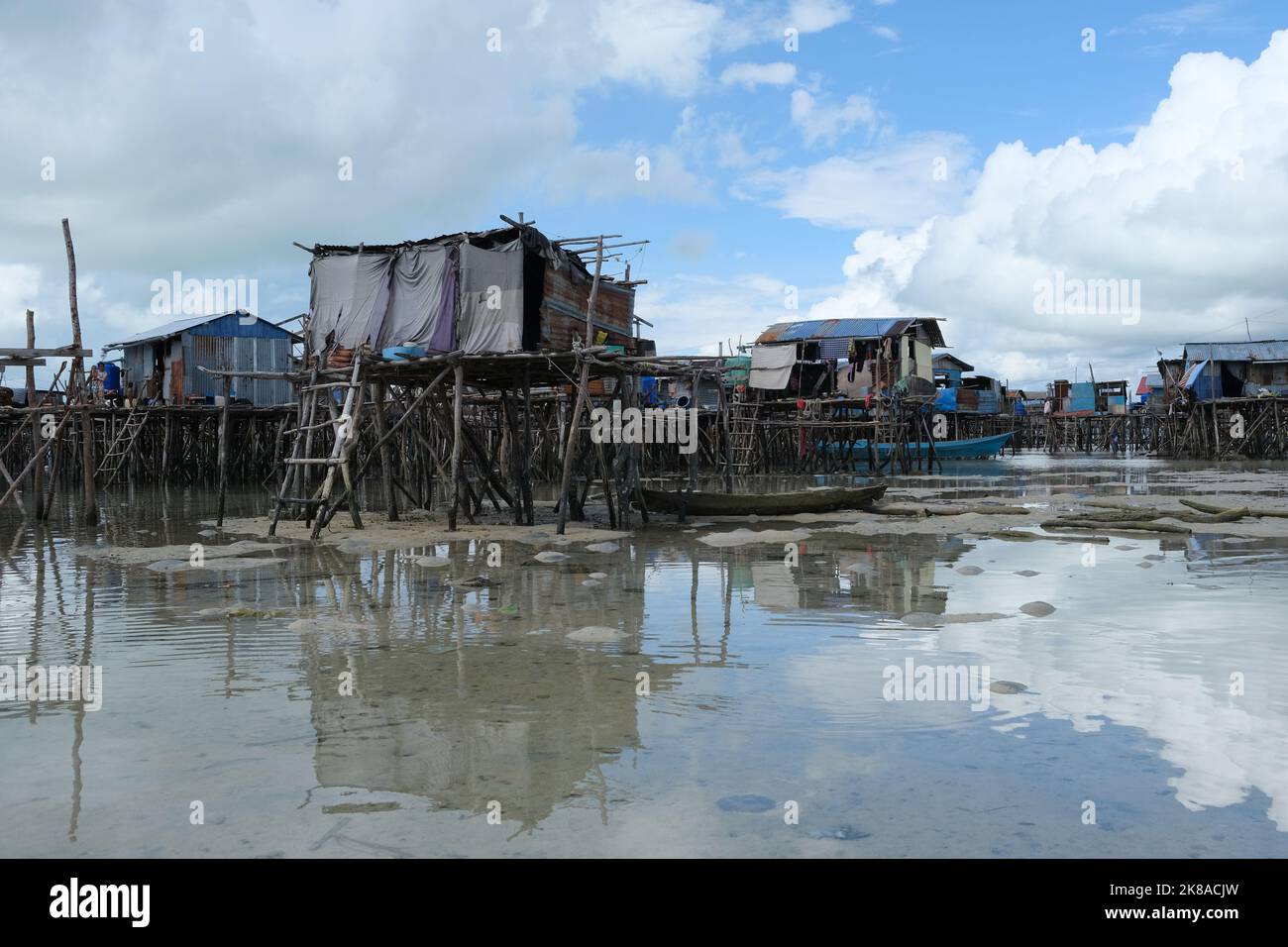 Omadal Island is a Malaysian island located in the Celebes Sea on the state of Sabah. The bajau laut village community during low tide time. Stock Photo