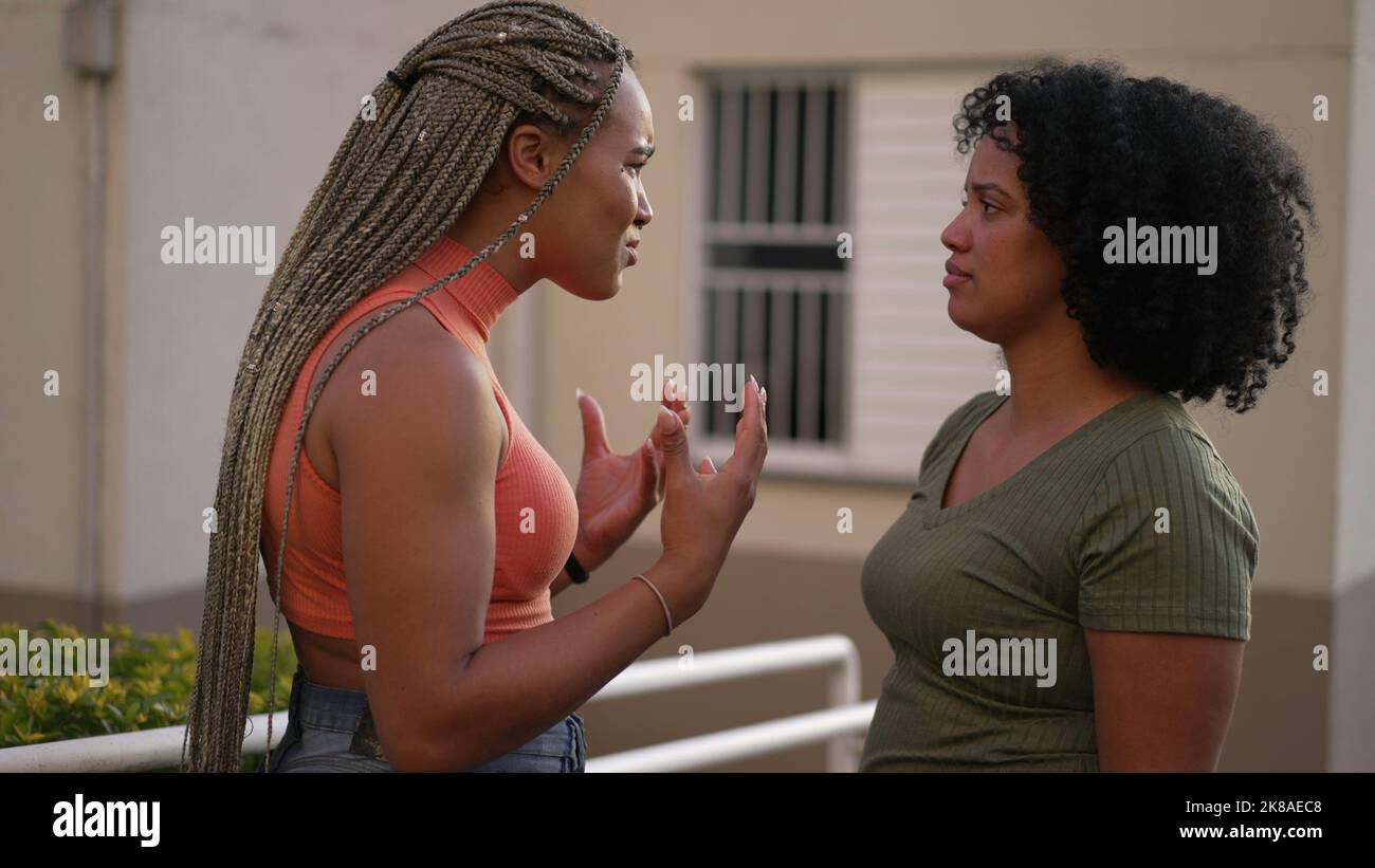 Female friend consoling desperate young woman. Two black sisters