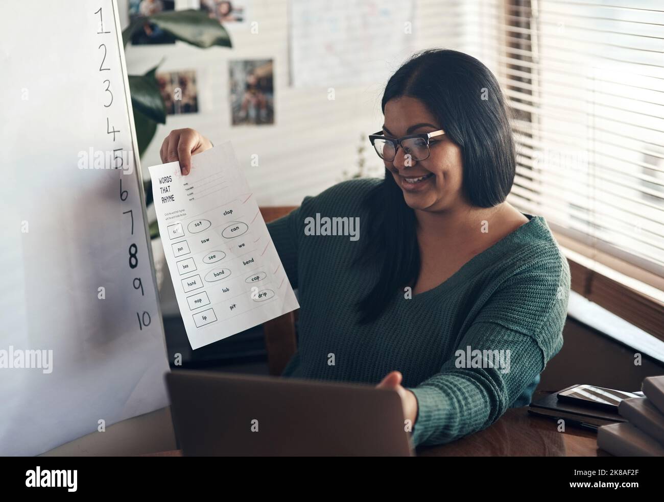 Online learning is still learning. a young woman using a laptop to teach a lesson from home. Stock Photo