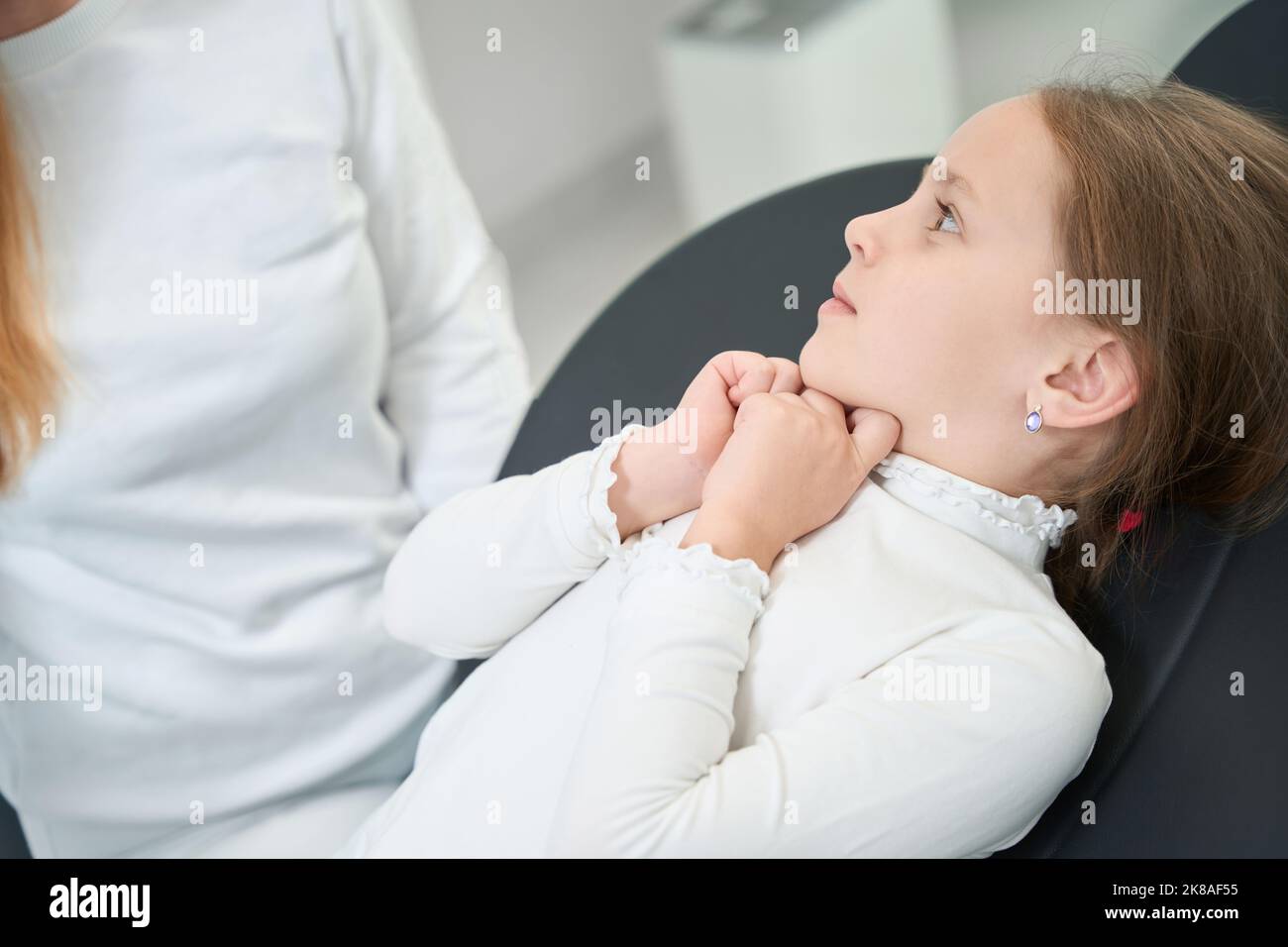 Scared little patient looking at pediatric dentist Stock Photo