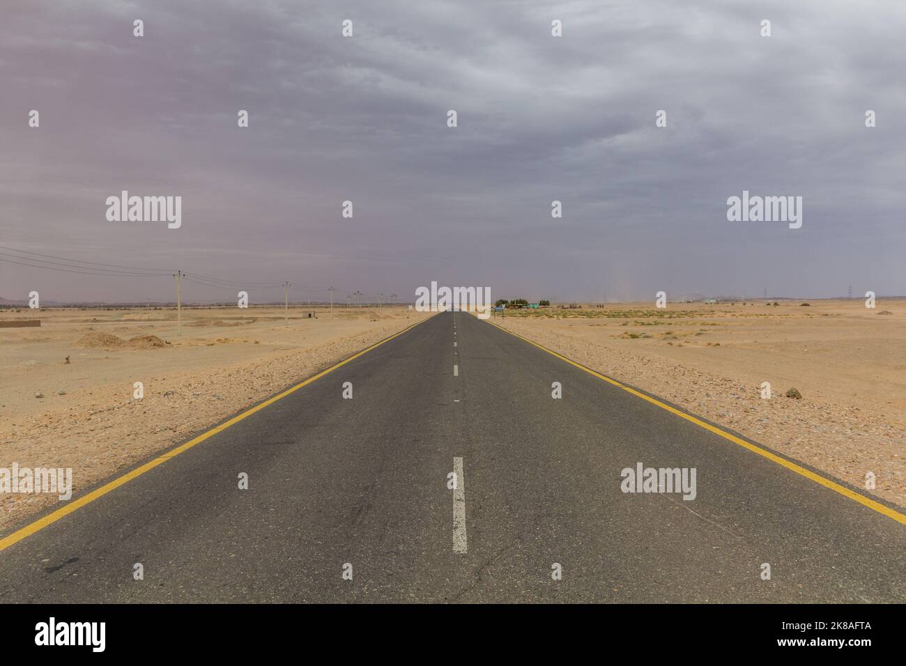 Straight desert road in northern Sudan Stock Photo