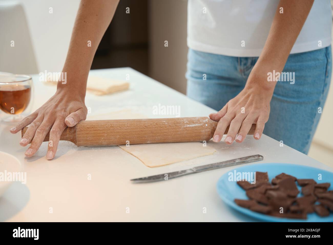 Woman rolling out sheet of dough using a rolling pin Stock Photo Alamy