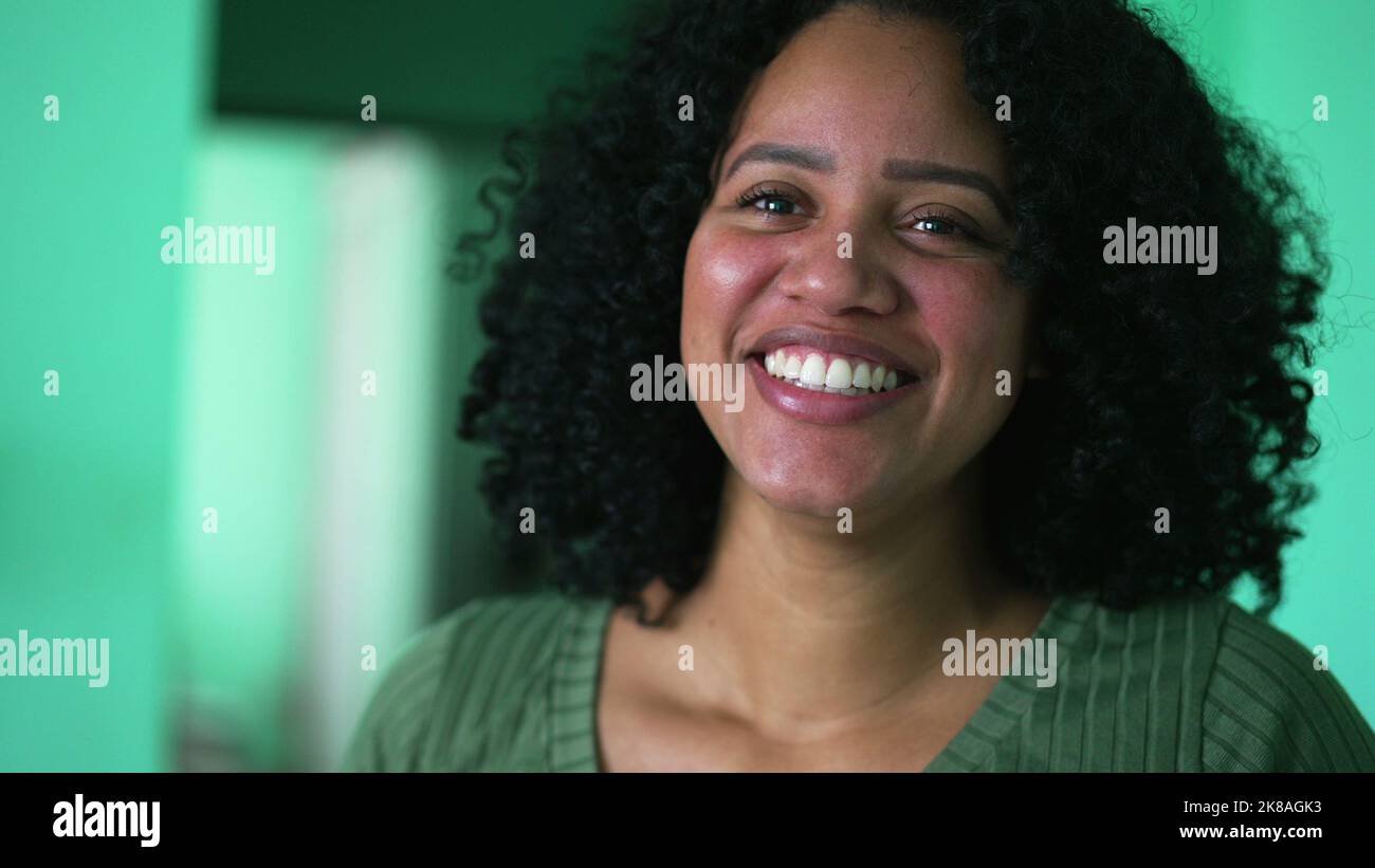 One young black woman laughing out loud portrait face real life laugh and smile Stock Photo