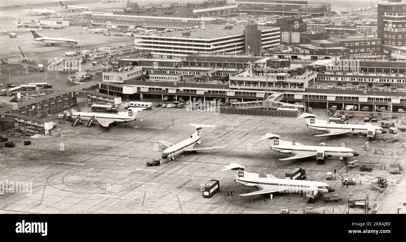 View from above of parking ramps of London Heathrow airport in late sixties. It is possible to identify several liner of different air companies, in particular some BEA Trident Three at gate. Stock Photo