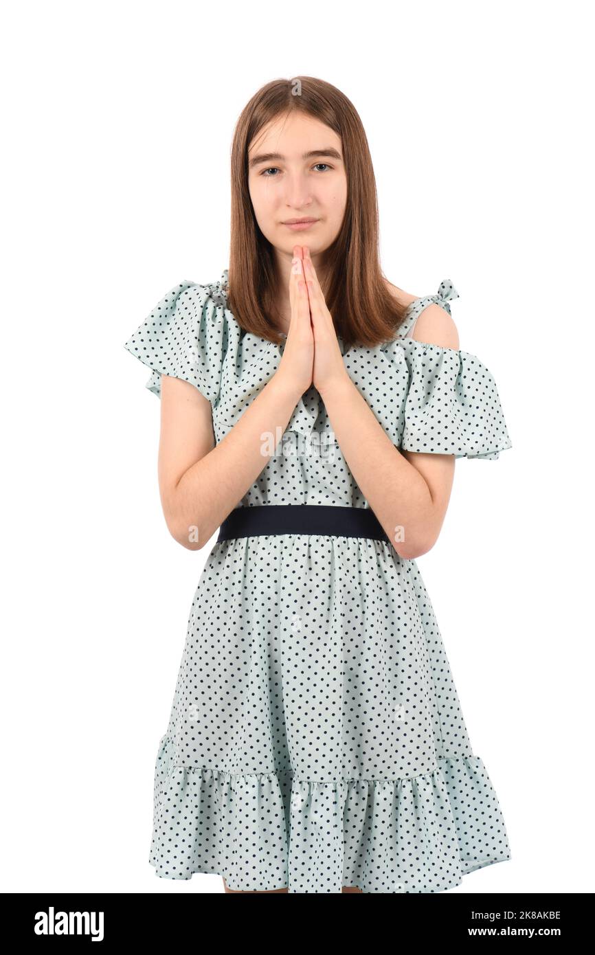 Young beautiful girl in a blue dress with polka dots on a white ...
