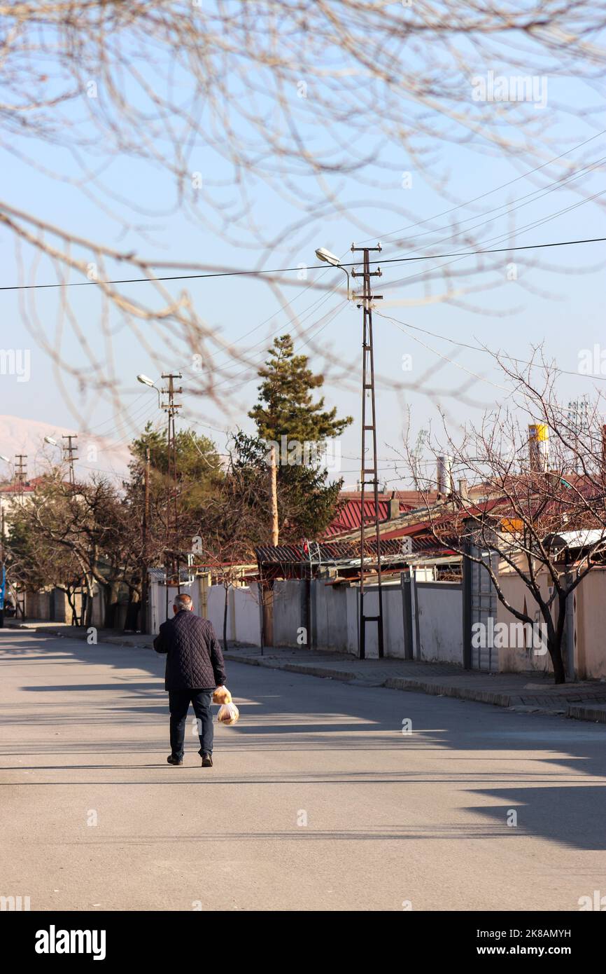 Street view from Erzincan. The man who goes home with bread in hand. Erzincan is a city in Turkey. Stock Photo