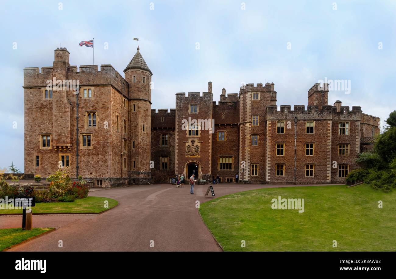 Dunster Castle, a former motte and bailey castle, now a country house, viewed from the gardens