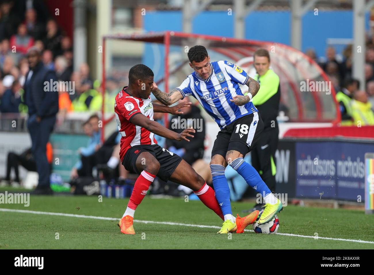Marvin Johnson #18 of Sheffield Wednesday is tackled by Timothy Eyoma #22 of Lincoln City during the Sky Bet League 1 match Lincoln City vs Sheffield Wednesday at Gelder Group Sincil Bank Stadium, Lincoln, United Kingdom, 22nd October 2022  (Photo by Arron Gent/News Images) in Lincoln, United Kingdom on 10/22/2022. (Photo by Arron Gent/News Images/Sipa USA) Stock Photo