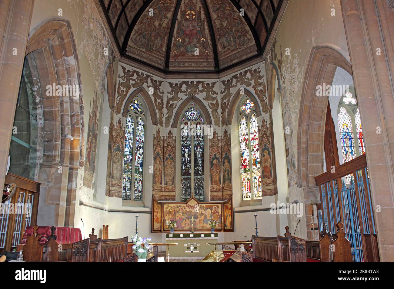 St James Church, New Brighton. Paintings, stained glass and reredos all designed by the eminent Victorian church artist Alfred O Hemming Stock Photo
