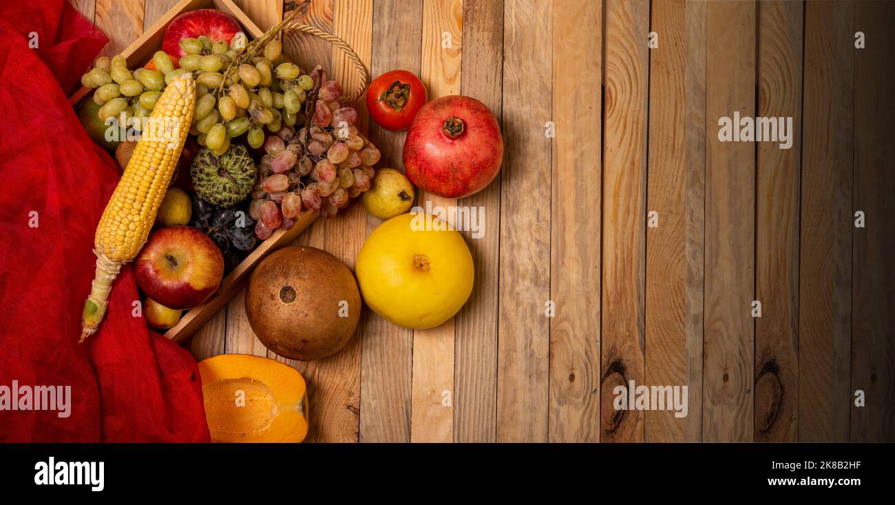 Farm fresh fruits basket with wooden table top view health and diet