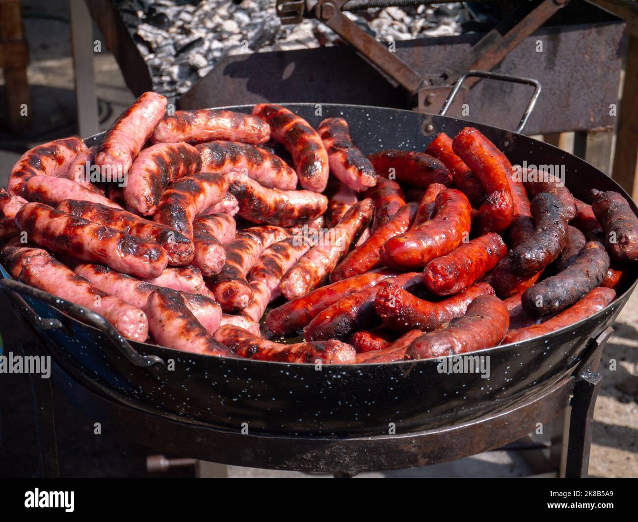 Spanish traditional fresh red and white sausages made on the charcoal