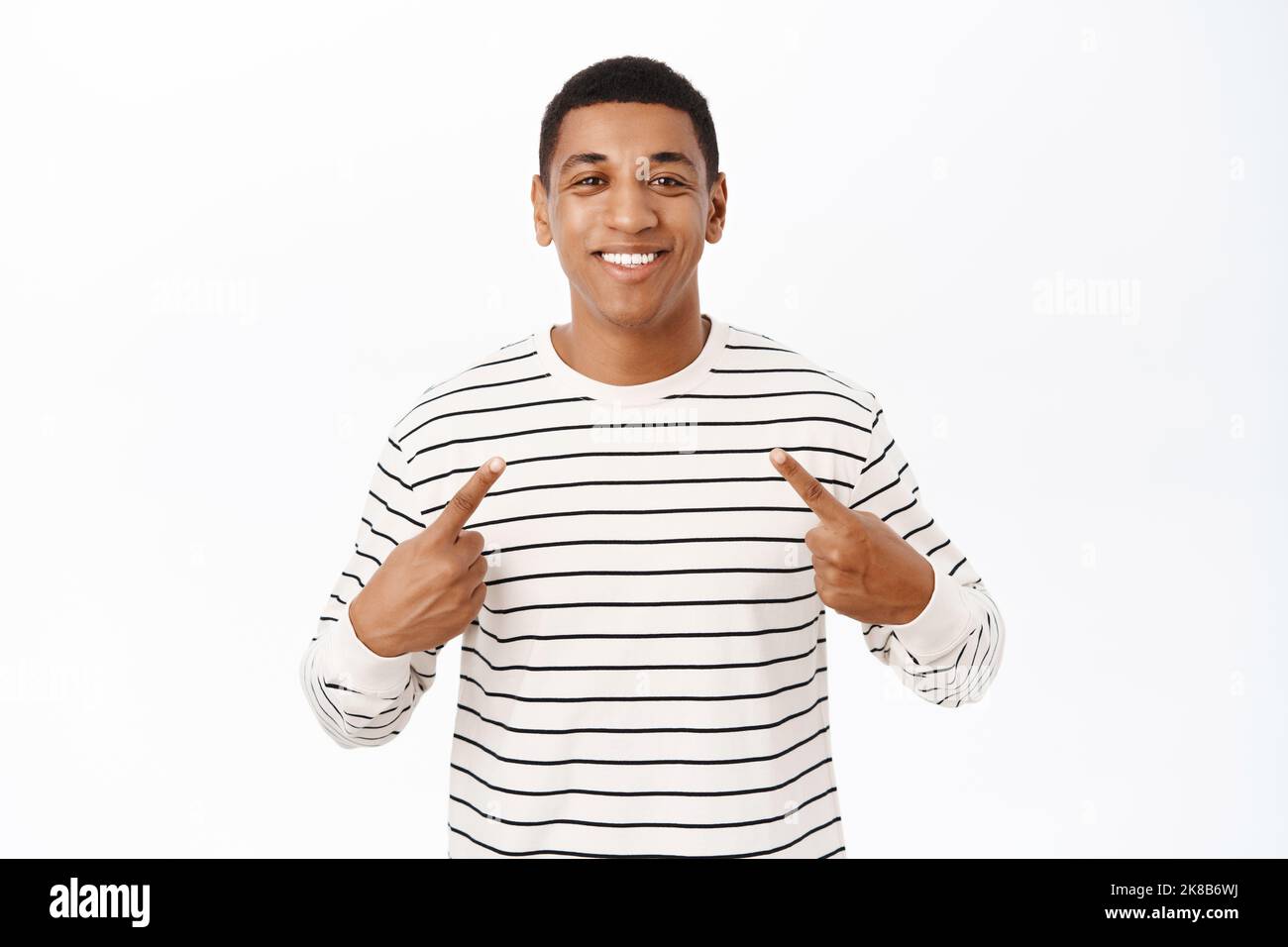 Image of smiling african american guy pointing at himself, self