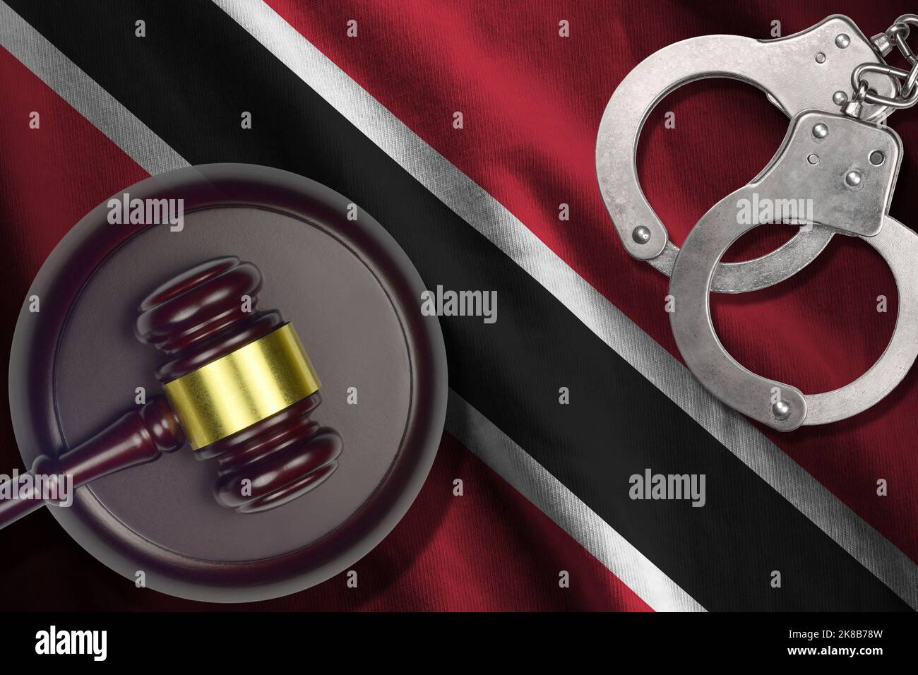 Trinidad and Tobago flag with judge mallet and handcuffs in dark room. Concept of criminal and punishment, background for guilty topics Stock Photo