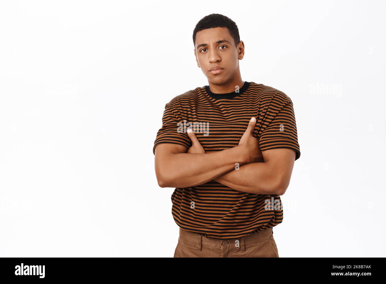 Serious Black man cross arms on chest, looking confident and ...
