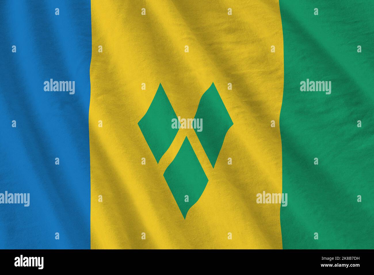 Saint Vincent and the Grenadines flag with big folds waving close up ...