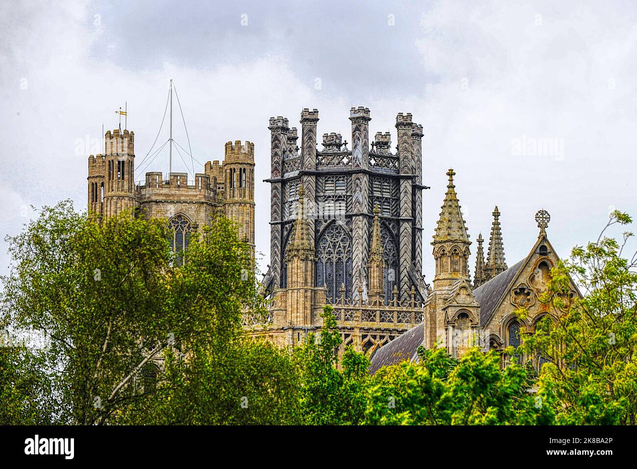 Ely Cathedral seen towering above the trees across the city Stock Photo