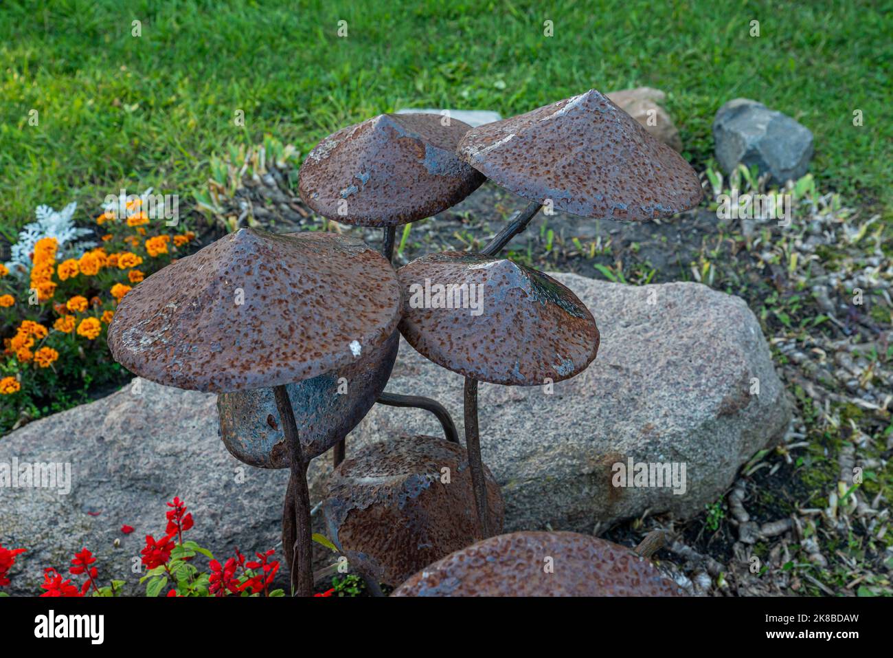 A garden sculpture of a toadstool, sculpture metal mushrooms rusted old in the park Stock Photo