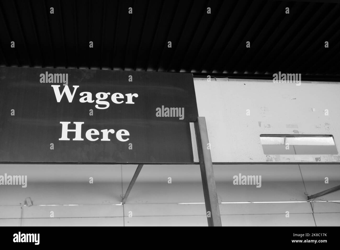 Wager Here sign at a racetrack; luck, chance, gambling, risk, wagering, betting, futures, investments, speculation, odds, Stock Photo