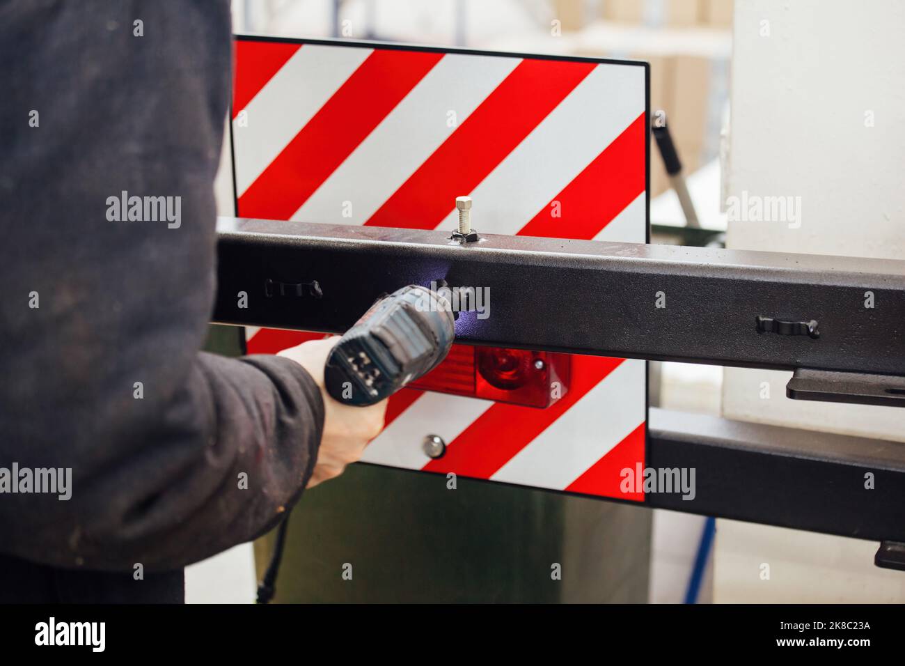 Industrial worker assembles machine, close up. Stock Photo