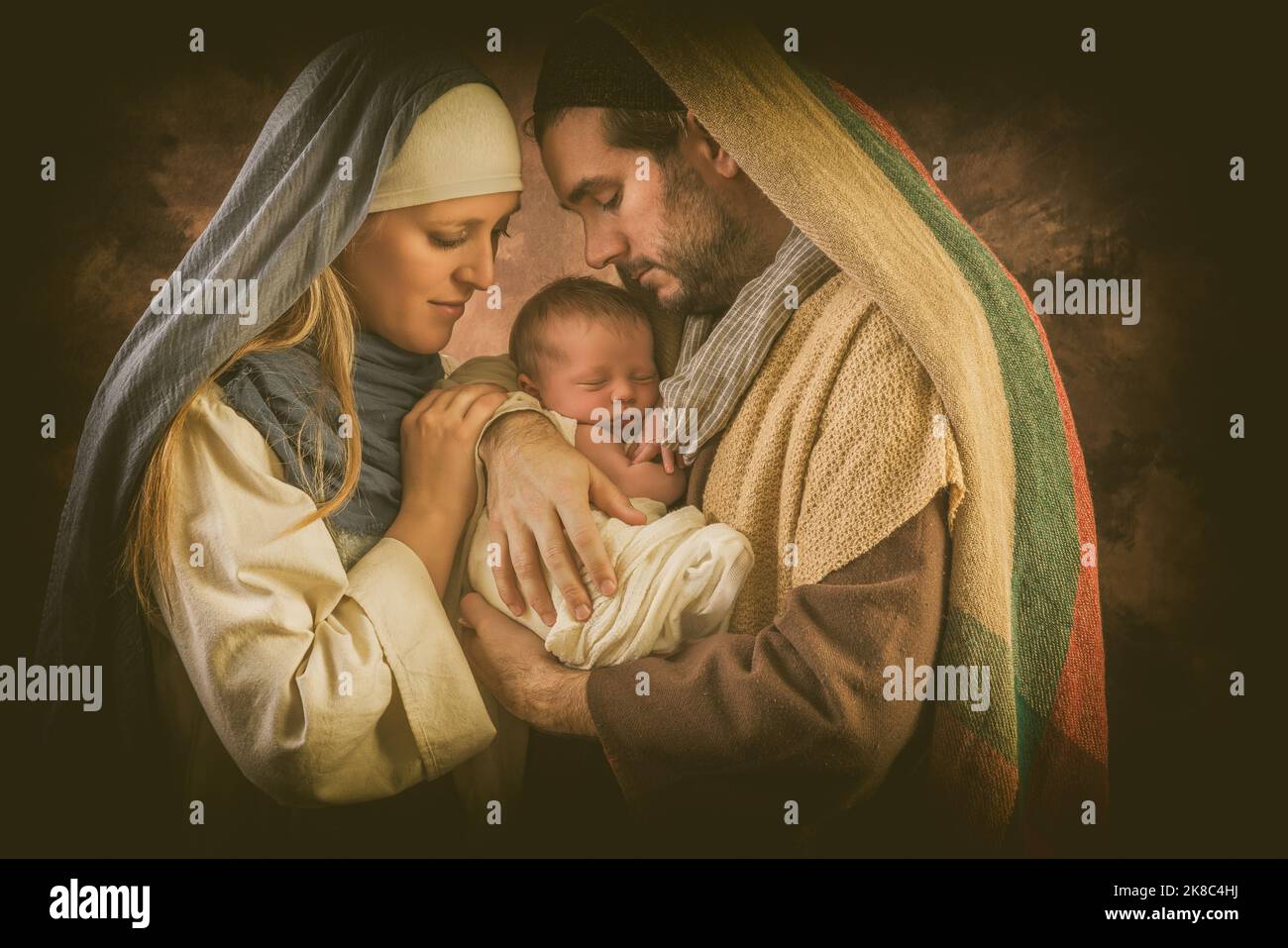 Proud parents during reenactment of a Christmas nativity scene with their own baby of 8 days old Stock Photo
