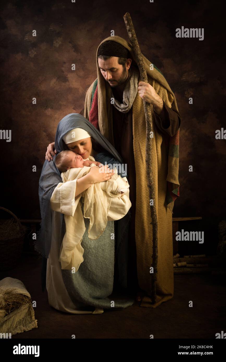 Proud parents during reenactment of a Christmas nativity scene with their own baby of 8 days old Stock Photo