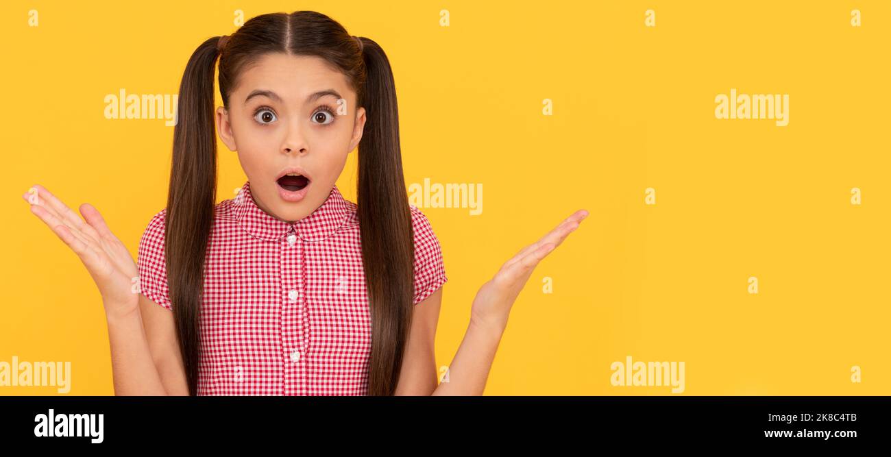 OMG. Surprised child yellow background. Wide-eyed girl got surprised. Surprise and shock. Child face, horizontal poster, teenager girl isolated Stock Photo