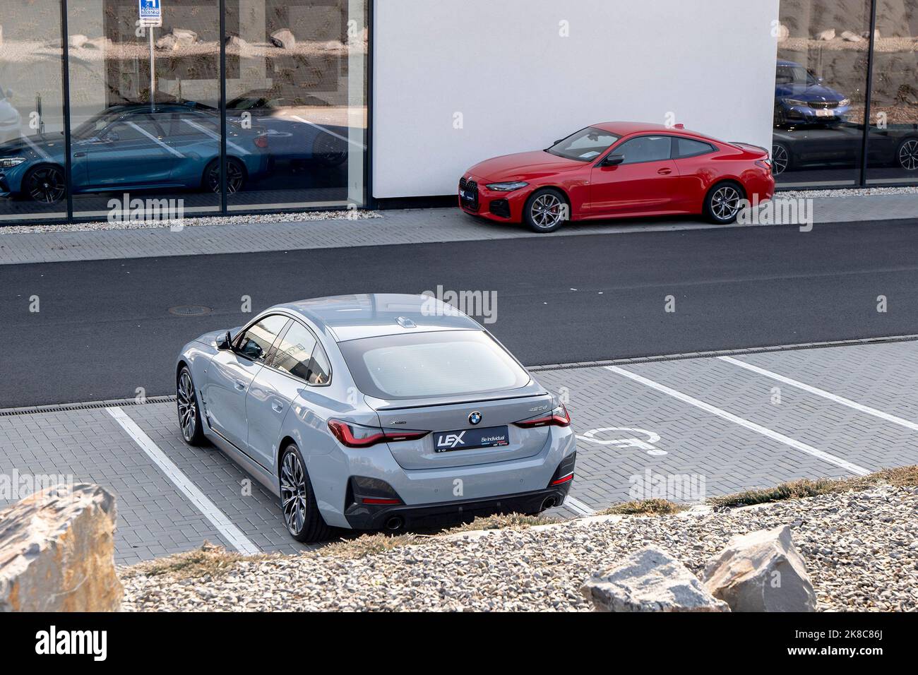 OSTRAVA, CZECH REPUBLIC - MARCH 1, 2022: BMW 420d vehicle in front of the dealership with red coupe in the background Stock Photo