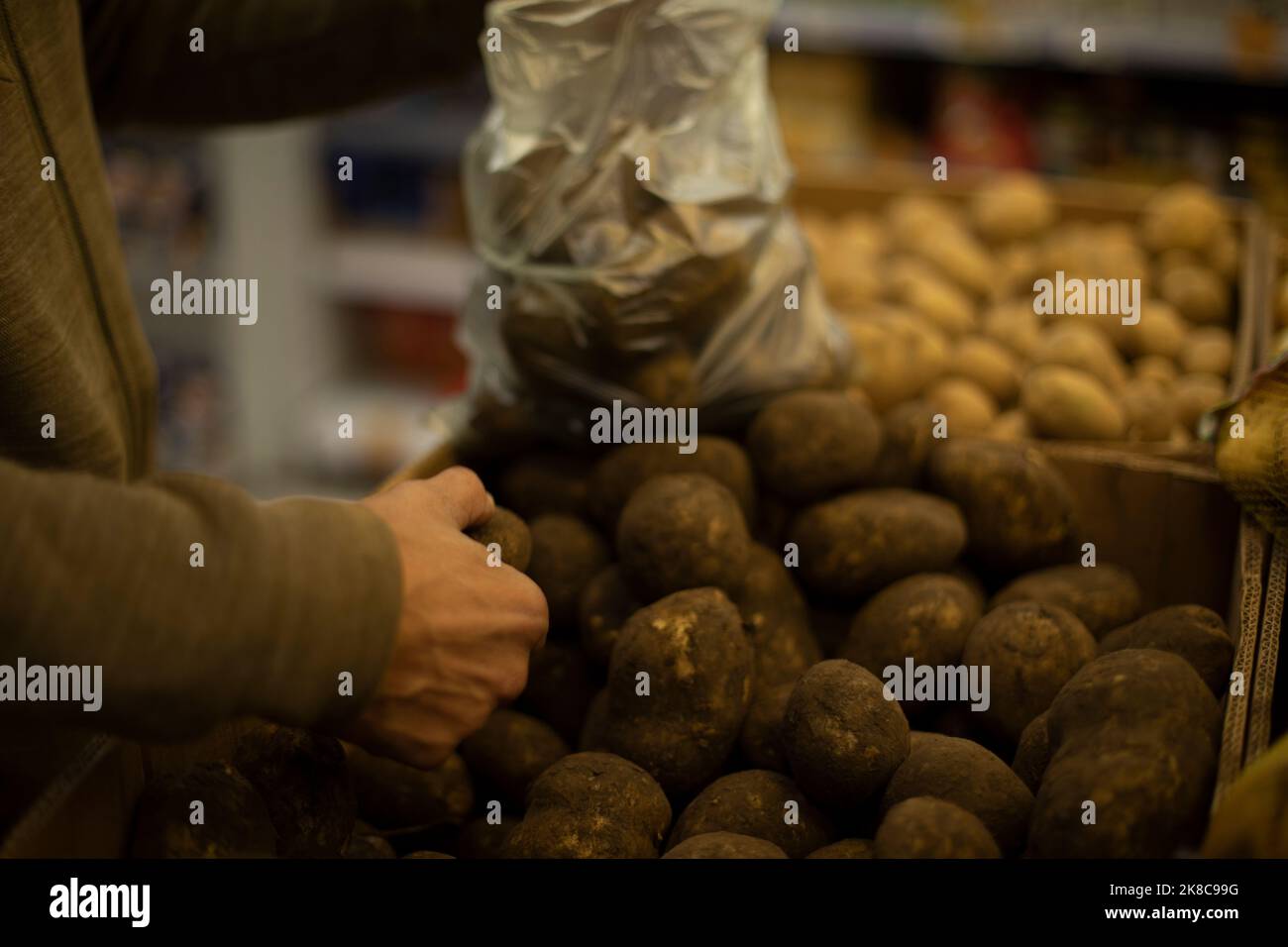 Bag with potatoes. Vegetables in kitchen. Potatoes in plastic bag