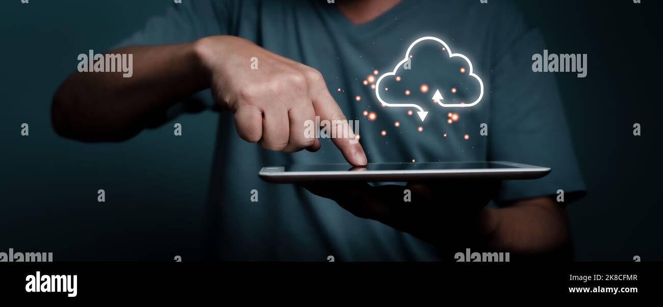 Hand touching tablet with white cloud computing network technology concept. Stock Photo