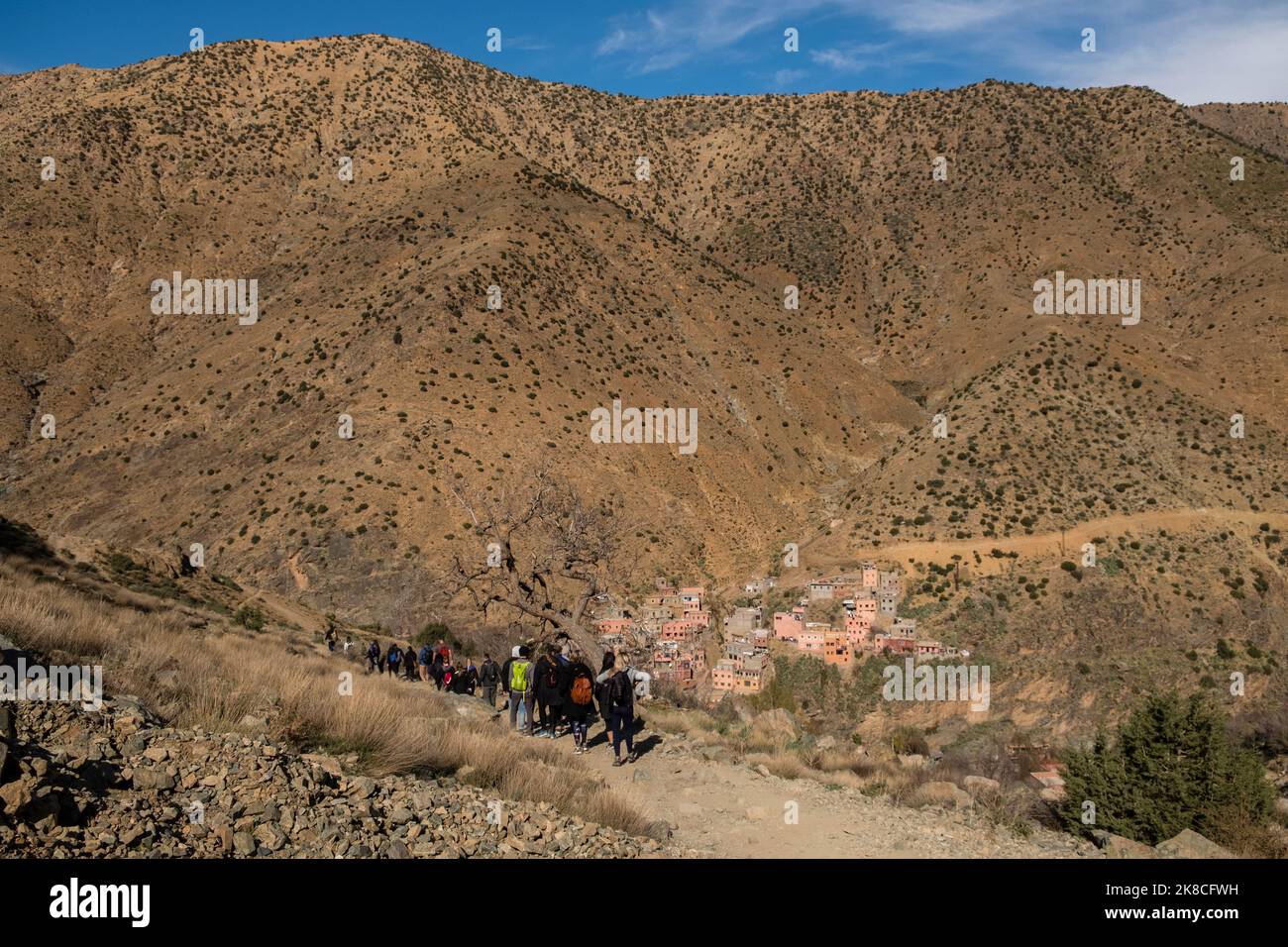 Tourists hiking in the Atlas Mountains with the ancient village of Setti Fatma in the background, Ourika Valley, Morocco, North Africa Stock Photo